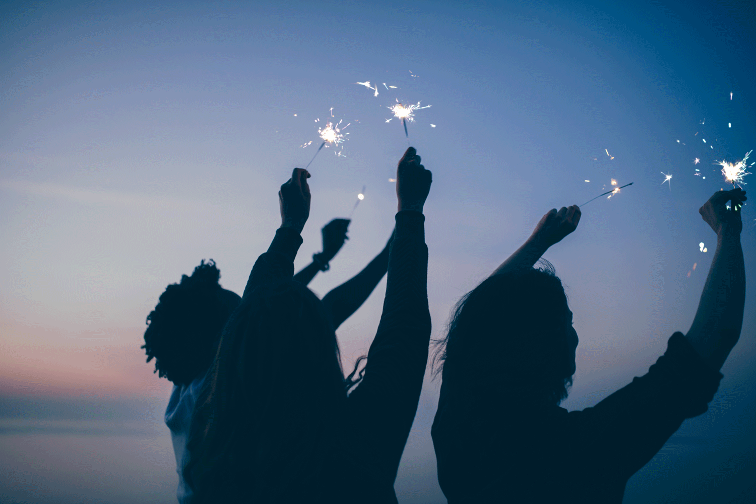 group of people holding sparklers